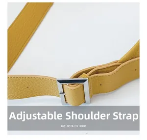 Detail of yellow lychee texture leather shoulder strap with silver square adjustment buckle