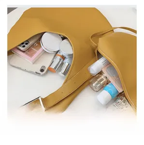 Top view of spacious interior of mustard yellow pebbled leather tote with matching pouch