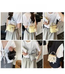 Detail showing various colors of crocodile textured bucket bags with pearl heart charms