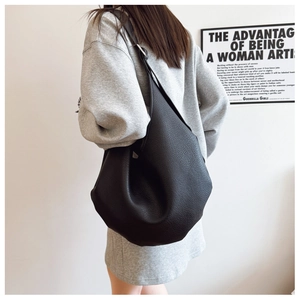 Close-up of black litchi grain leather hobo bag showing texture and large capacity
