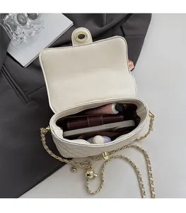 Internal view of beige quilted crossbody bag showing spacious main compartment with essentials