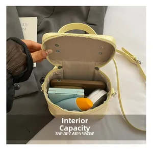 Internal capacity of light yellow embossed leather bag with essentials and herringbone lining