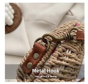 Detail of vintage bronze hardware and brown leather strap on woven straw saddle bag