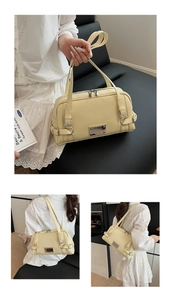 Detail of light yellow Boston bag showing leather texture and silver metal buckle