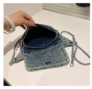 Detail showing the inner storage space and zipper of the vintage denim crossbody bag