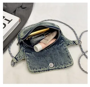 Interior detail of vintage light blue denim crossbody bag showing ample storage space