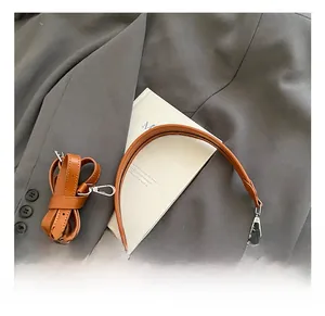 Détail du sac tissé multicolore avec poignées en cuir marron et garnitures métalliques