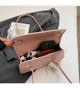 Pink pleated leather shoulder bag showing large interior capacity with phone and wallet