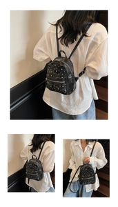 Detail view of mini black backpack with silver rivets and quilted faux leather texture