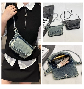 Detailed interior of vintage denim crossbody bag showing makeup storage and silver chain
