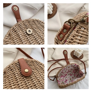 Detail of a round straw bag with magnetic buckle and floral print lining for summer