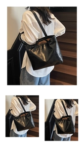 Detail of black crocodile embossed tote bag on shoulder for daily commute and casual style