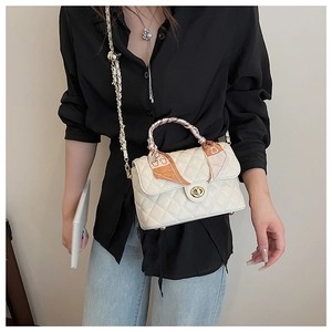 Chic quilted crossbody bag with golden twist lock and decorative silk scarf detail