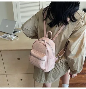 Détail du mini sac à dos de voyage rose avec strass brillants et fermetures éclair argent