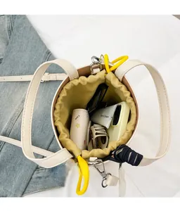 Top view of cream bucket bag with yellow drawstring interior showing large storage capacity
