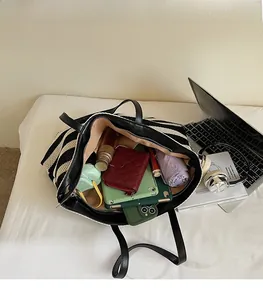 Spacious interior of striped knit tote bag showing capacity for daily essentials