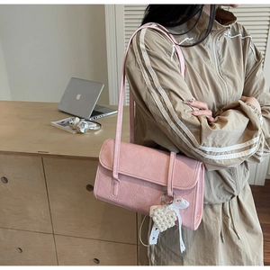 Pink pleated faux leather shoulder bag with pearl heart charm and lace bow detail
