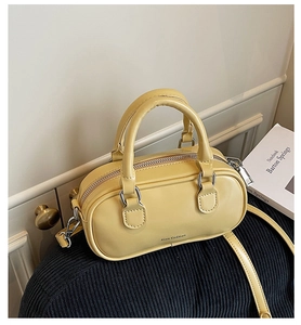 Detail of light yellow Boston mini bag with Jian GeDiao logo and silver hardware