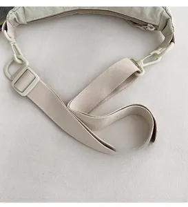 Detail of adjustable nylon shoulder strap with swivel hook and buckle for crossbody bags