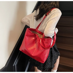 Detailed view of red crocodile-patterned tote bag showing large capacity and texture