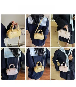 Detailed views of mini Boston bag in yellow and light pink with adjustable straps
