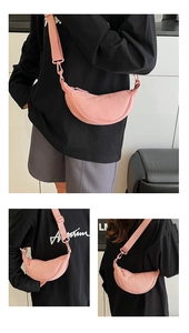 Detail of pink crescent bag showing lightweight nylon fabric and adjustable wide shoulder strap
