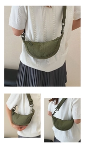 Detail view of olive green crescent bag showing nylon texture and adjustable wide strap