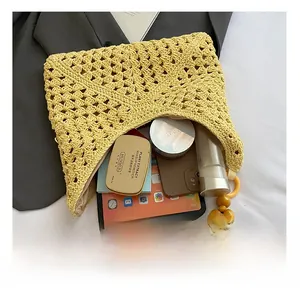 Detail of yellow knit tote with wooden beads showing spacious interior for essentials