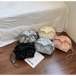 Detail of ruched cloud bags in five colors with sparkling rhinestones and chain straps
