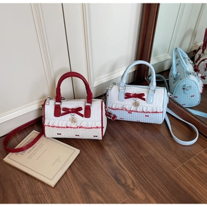 Sweet cylindrical crossbody bag with decorative bow and heart pendant in two colors