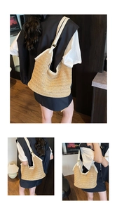 Detail of the woven straw bag with white leather straps and trim for summer beach style