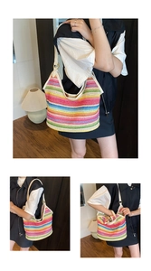 Detail of colorful striped woven hobo bag with adjustable cream shoulder strap and metal buckle