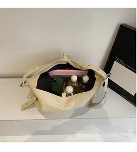 Interior view of large capacity beige canvas tote bag showing spacious storage compartments