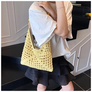 Detailed close-up of yellow crochet tote bag with woven hollow diamond pattern and lining
