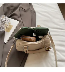 Interior view showing the storage capacity of the beige bowling bag with two phones