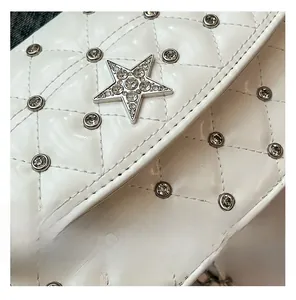 Detail of white quilted leather with crystal star emblem and sparkling rhinestones