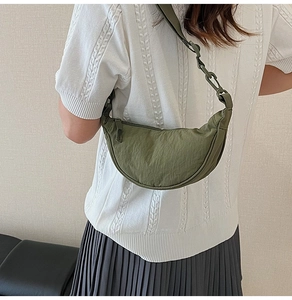 Olive green nylon crescent bag with adjustable wide strap shown in a side-back view