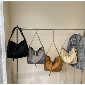Detail view of large canvas hobo bags with adjustable eyelet straps in four colors