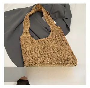 Close-up of the fine texture and craftsmanship of the khaki hand-woven tote bag