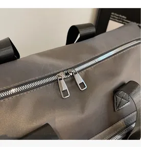 Close-up of durable dual metal zippers and nylon handle on travel sports bag