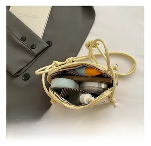 Interior view of yellow crossbody shell bag showing storage space for phone and makeup