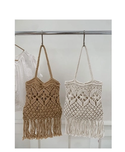 Detail of handmade bohemian woven tote bag with fringe tassels and hollow mesh design