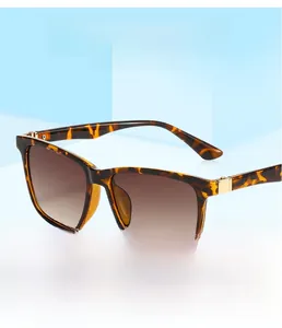Detail of tortoise shell square sunglasses with gradient brown lenses and metal hinges