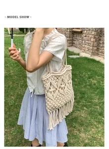 Outdoor model show of a beige handmade macrame woven tote bag with long tassels