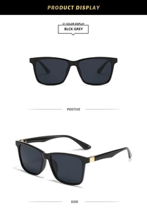 Detail view of square black sunglasses with gold hinge accents and dark grey lenses