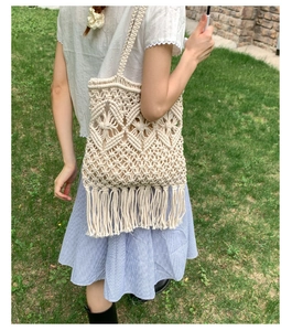Close-up of bohemian woven tote bag with fringe details and intricate mesh texture