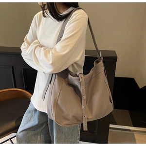 Detail view of adjustable metal buckle on vintage large canvas hobo shoulder bag