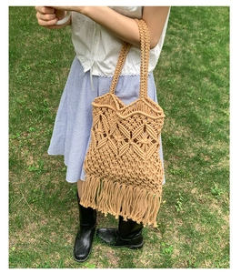 Detailed view of hand-woven hollow diamond pattern and long fringe on beige tote bag