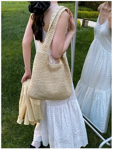 Detail of hand-woven beige hobo bag with large capacity for summer beach vacations