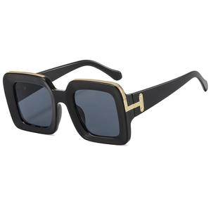 Modern oversized square sunglasses with black frames and signature golden T-hinge accents